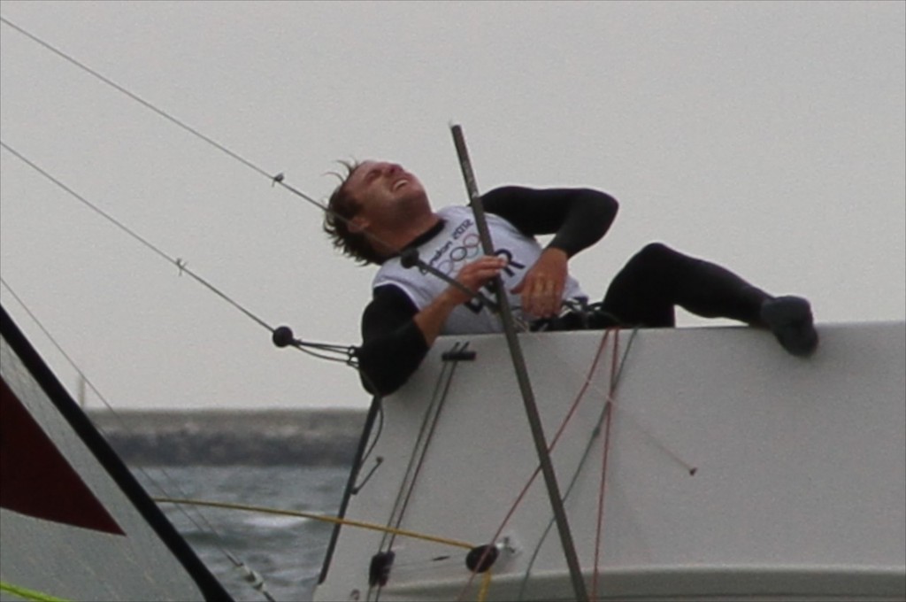 August 1, 2012 - Weymouth, England - 49er crewman Alexander Kirkland (BER) screams in agony as their 49er, he races with brother Jesse Kirkland, capsizes close to the finish. They were unable to right their boat and continue sailing  © Richard Gladwell www.photosport.co.nz